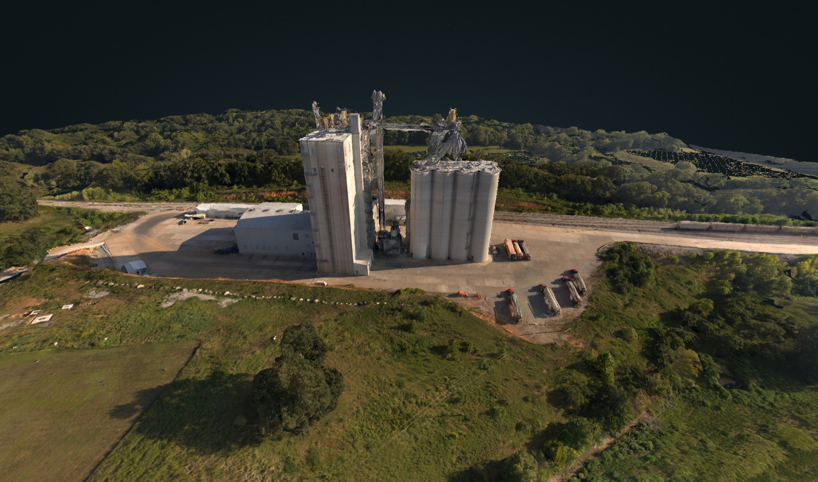 Aerial photo of a feed mill and grain silo facility at golden hour